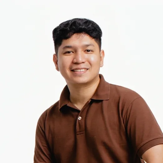 Paul Prado Pacardo, smiling, in a brown polo shirt